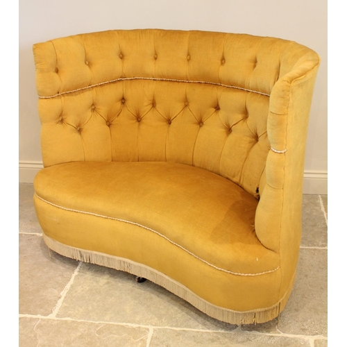 713 - An early 20th century button back love seat, upholstered in yellow velour, the wrap around high back... 