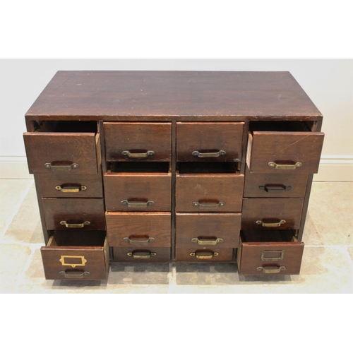 724 - A George V oak filing cabinet, with an arrangement of sixteen small drawers, raised upon later feet,... 