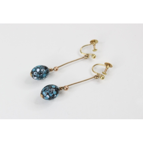 97 - A pair of 9ct gold drop earrings, each comprising a polished oval turquoise coloured bead (measuring... 