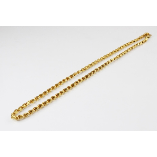 132 - A yellow gold fancy-link chain, with lobster claw fastening stamped '750', 47cm long, weight 29.1gms