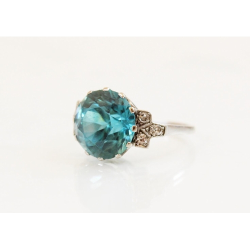 143 - An Art Deco blue zircon and diamond ring, the central round mixed cut zircon (measuring 12mm diamete... 