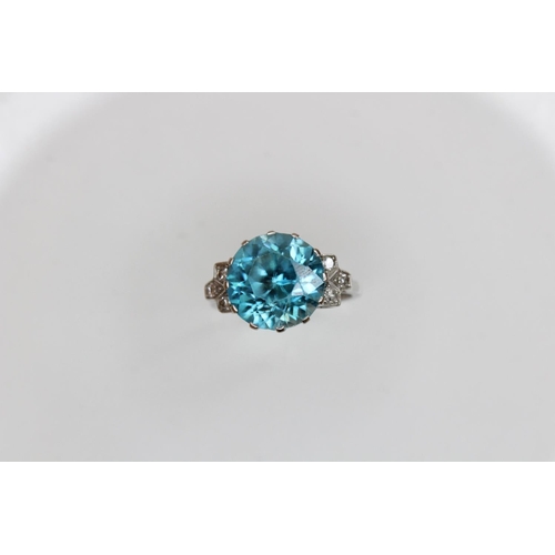 143 - An Art Deco blue zircon and diamond ring, the central round mixed cut zircon (measuring 12mm diamete... 