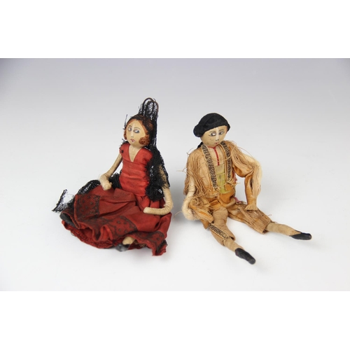 186 - Two silk Spanish dolls, early 20th century, one modelled as a matador, 14cm high, the other as a fla... 