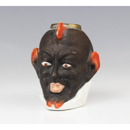 192 - A brass mounted painted vesta pot, probably 19th century, modelled as a devil or demon mask with mou... 