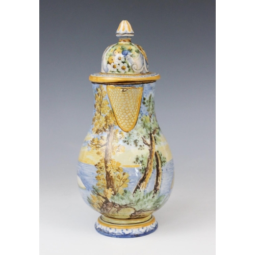 256 - An Italian faience ewer and cover in the manner of Cantagalli, 20th century, decorated with a landsc... 