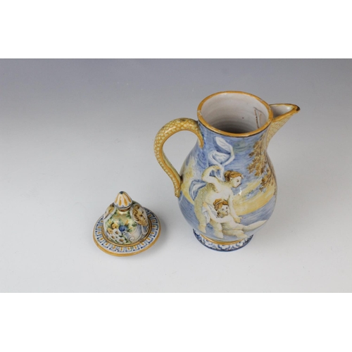 256 - An Italian faience ewer and cover in the manner of Cantagalli, 20th century, decorated with a landsc... 