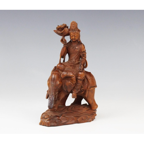 286 - A Chinese sandalwood carving of Guanyin upon an elephant, 16.5cm high (at fault)