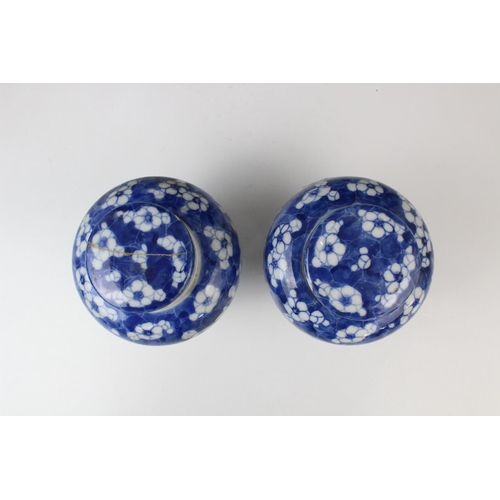 289 - A pair of Chinese blue and white prunus pattern vases and covers, each of slender baluster form, 21c... 