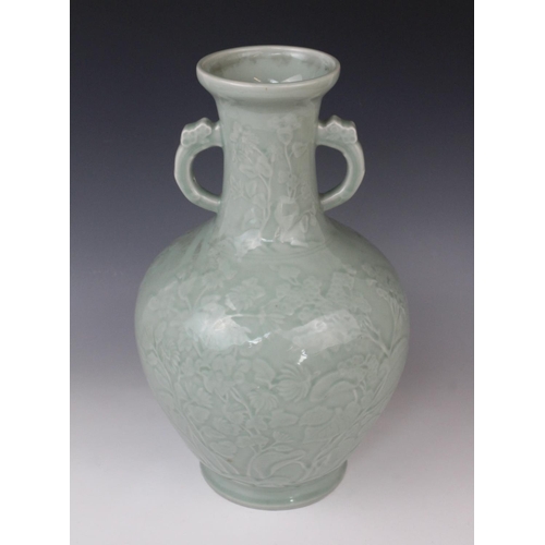 291 - A Chinese Longquan celadon glazed vase, 20th century, the arrow-head type shaped twin handled vase d... 