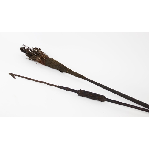 300 - A Naga Tribe spear, 19th century, with barbed iron terminal and carved figural shaft with dyed feath... 