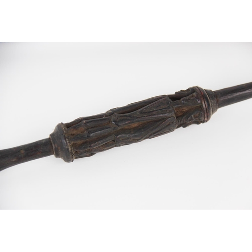 300 - A Naga Tribe spear, 19th century, with barbed iron terminal and carved figural shaft with dyed feath... 