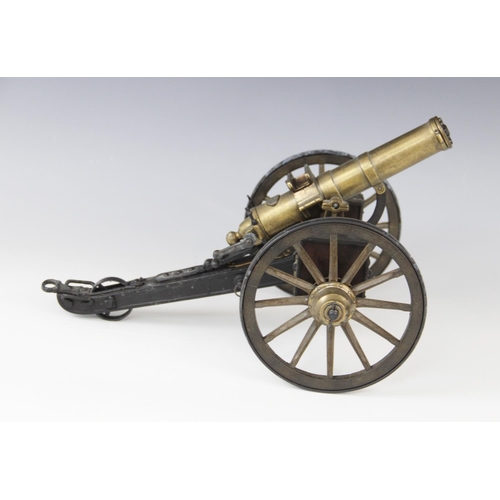 315 - A desktop model of a Gatling field gun, the turned brass barrel set to a tilt mechanism on painted m... 