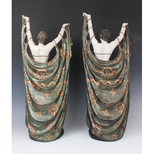 345 - A pair of composite Art Deco style faux chryselephantine figures, late 20th century, modelled in the... 