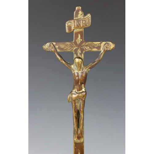 357 - A cast brass crucifix, possibly French, the tall cross with foliate motifs, 'INRI' plaque and skull ... 