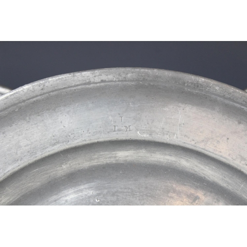 384 - A pewter charger, of typical form with 'I P S' stamped to the rim, probably made by W. Cooke, crowne... 