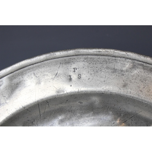 384 - A pewter charger, of typical form with 'I P S' stamped to the rim, probably made by W. Cooke, crowne... 