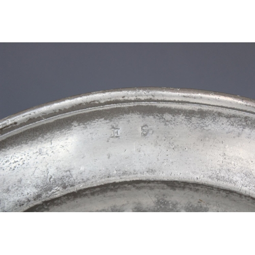 384 - A pewter charger, of typical form with 'I P S' stamped to the rim, probably made by W. Cooke, crowne... 