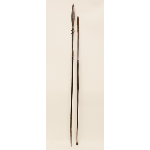 A tribal fishing spear, the metal head with barbed collar and