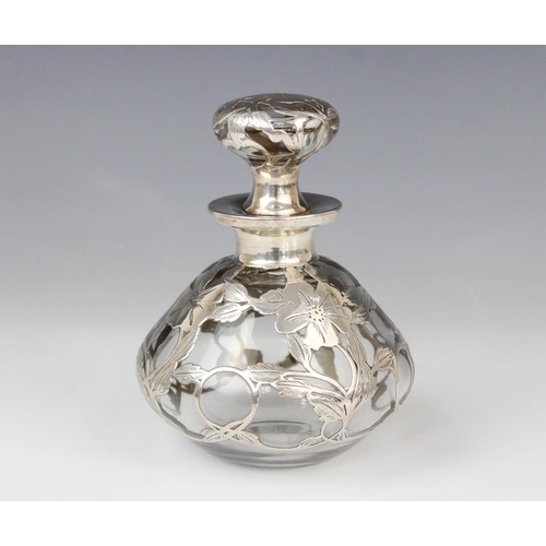 58 - An Art Nouveau glass scent bottle, of compressed baluster form with flared neck and stopper, the col... 