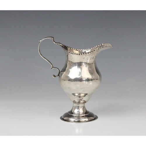 65 - A George III silver cream jug, marks for George Smith (II), London 1778, of baluster form on domed c... 