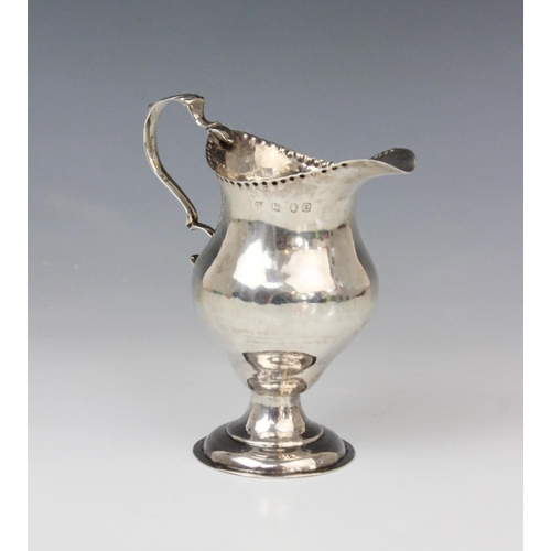 65 - A George III silver cream jug, marks for George Smith (II), London 1778, of baluster form on domed c... 