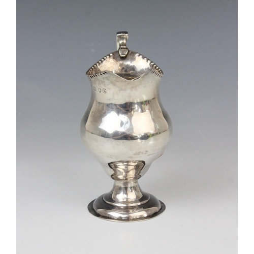 65 - A George III silver cream jug, marks for George Smith (II), London 1778, of baluster form on domed c... 