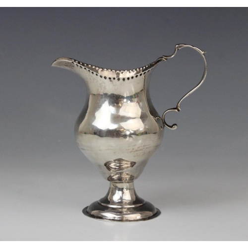 65 - A George III silver cream jug, marks for George Smith (II), London 1778, of baluster form on domed c... 