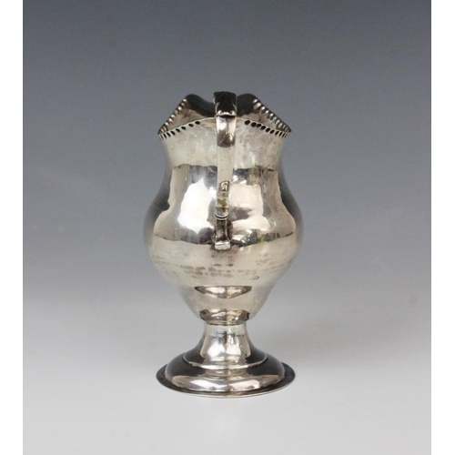 65 - A George III silver cream jug, marks for George Smith (II), London 1778, of baluster form on domed c... 