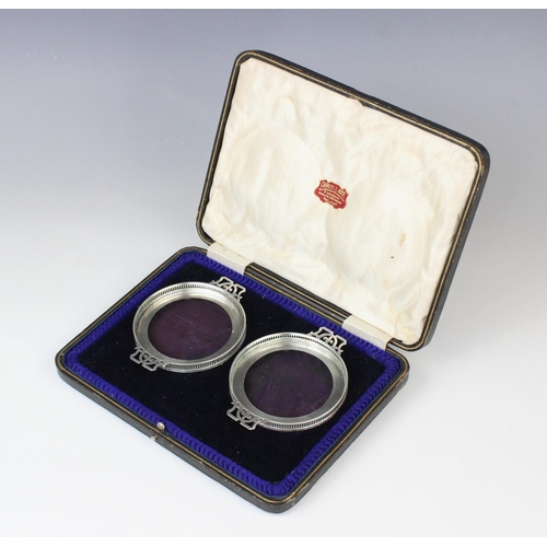 66 - A cased pair of George V silver mounted glass dishes by Adie Brothers, Birmingham 1935, each of circ... 