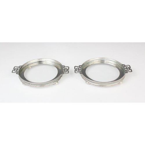 66 - A cased pair of George V silver mounted glass dishes by Adie Brothers, Birmingham 1935, each of circ... 