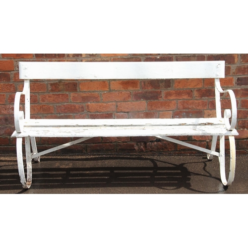 427 - A 19th century painted iron and hardwood bench, the pair of scrolling strapwork supports united by a... 