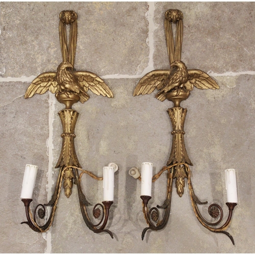 572 - A pair of 19th century gilt wood and gesso pendant wall sconces, each with a rams mask terminal abov... 