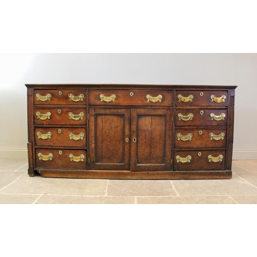 606 - A mid 18th century oak Welsh dresser, the inverted breakfront dresser rack with a moulded cornice ov... 