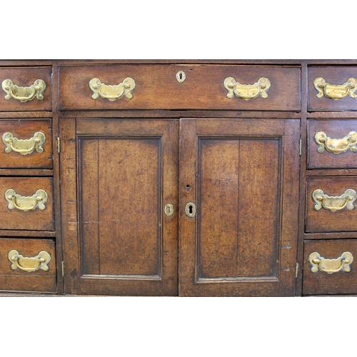 606 - A mid 18th century oak Welsh dresser, the inverted breakfront dresser rack with a moulded cornice ov... 