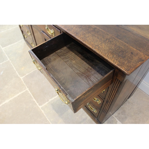 606 - A mid 18th century oak Welsh dresser, the inverted breakfront dresser rack with a moulded cornice ov... 