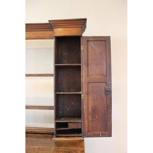 606 - A mid 18th century oak Welsh dresser, the inverted breakfront dresser rack with a moulded cornice ov... 