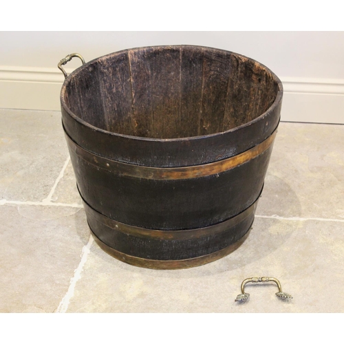 676 - A 19th century coopered oak and brass bound log barrel, of typical tapering form with three brass ba... 