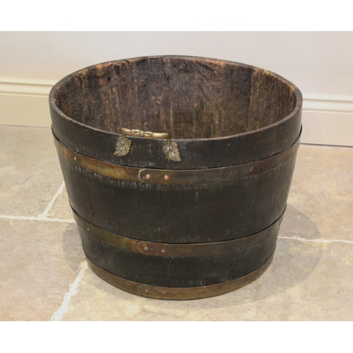 676 - A 19th century coopered oak and brass bound log barrel, of typical tapering form with three brass ba... 