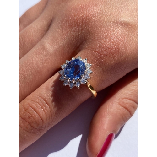 167 - A sapphire and diamond cluster ring, the central oval mixed cut sapphire (measuring approximately 9.... 