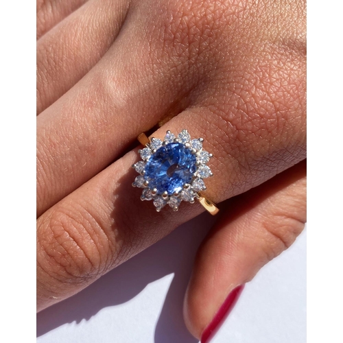 167 - A sapphire and diamond cluster ring, the central oval mixed cut sapphire (measuring approximately 9.... 