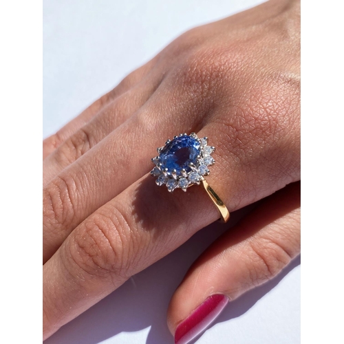 167 - A sapphire and diamond cluster ring, the central oval mixed cut sapphire (measuring approximately 9.... 