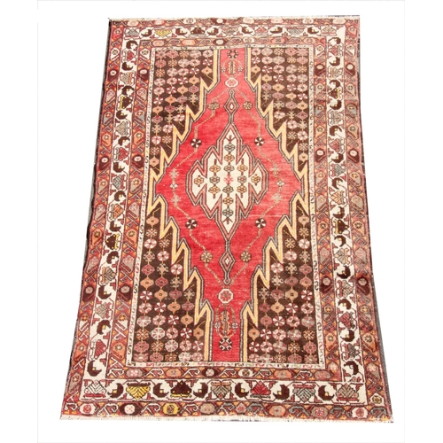 387 - A Turkish Ziegler carpet, the central red lozenge shaped medallion, on a brown ground with multiple ... 