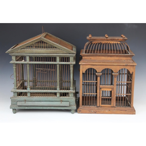 421 - A painted wood and wire work architectural bird cage, 20th century, the triangular gable and twin ra... 