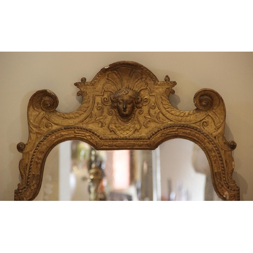 571 - A George I gilt wood and gesso wall mirror in the manner of John Belchier, the shell form pediment c... 