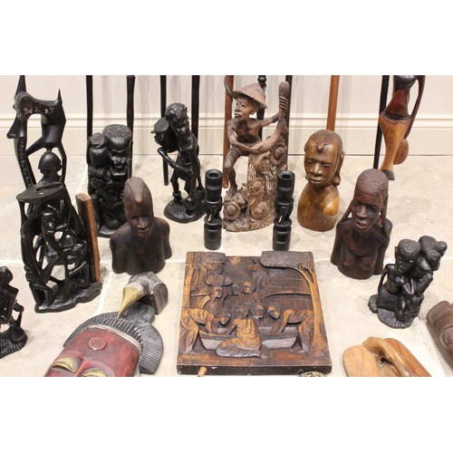 312 - A collection of Tribal carvings, predominantly from East Africa, to include a carved panel, 36cm x 3... 