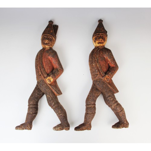 385 - A pair of Central American cast iron figural fire dog terminals, 19th century, each modelled as a re... 