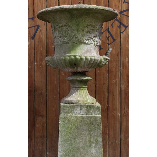 426A - A reconstituted stone campana garden urn, of typical lobed form, moulded in relief with scrolling fo... 