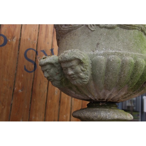 426A - A reconstituted stone campana garden urn, of typical lobed form, moulded in relief with scrolling fo... 