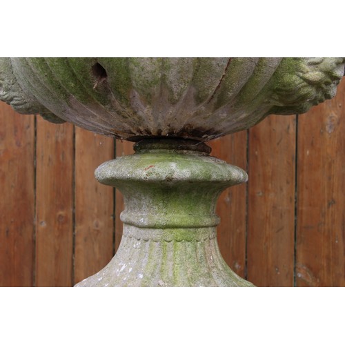 426A - A reconstituted stone campana garden urn, of typical lobed form, moulded in relief with scrolling fo... 