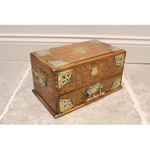 367 - A Victorian oak stationery box, applied with a brass shield shaped cartouche, openwork spandrels and... 